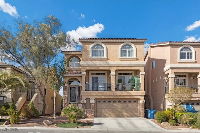 mediterranean / spanish-style house with an attached garage, stucco siding, stairs, and concrete driveway