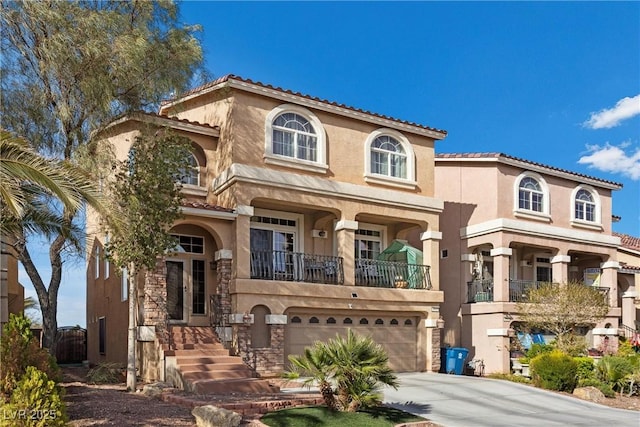 mediterranean / spanish-style house featuring concrete driveway, stucco siding, an attached garage, and a tile roof