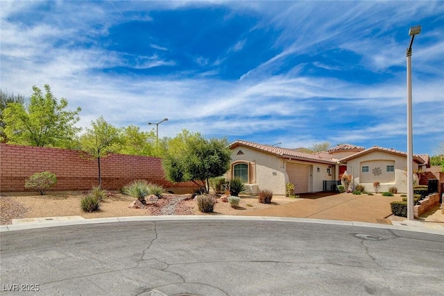 11342 Early Sun Ct, Las Vegas, NV 89135 - view of front of house with a tiled roof, stucco siding, fence, an attached garage, and concrete driveway