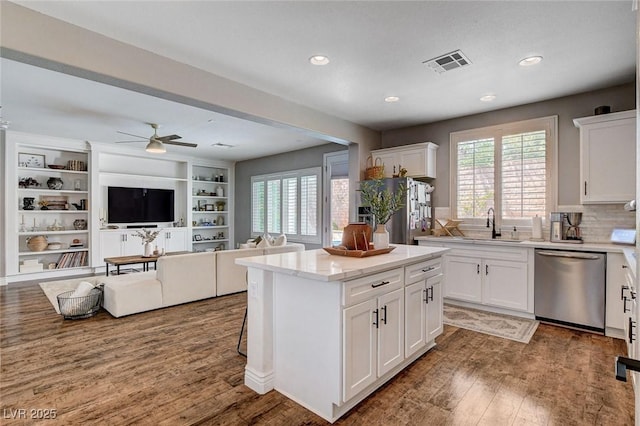 11342 Early Sun Ct, Las Vegas, NV 89135 - kitchen with visible vents, plenty of natural light, wood finished floors, and stainless steel appliances