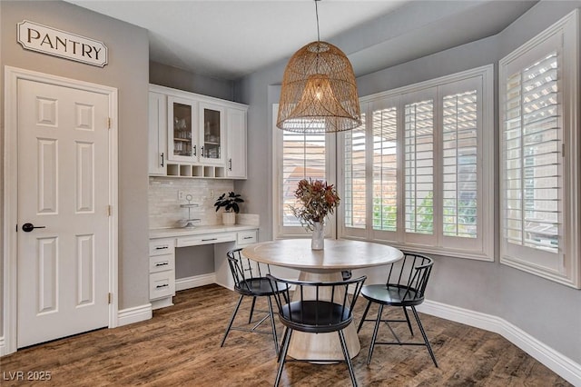 11342 Early Sun Ct, Las Vegas, NV 89135 - dining space with dark wood-type flooring, baseboards, an inviting chandelier, and built in study area