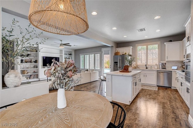 11342 Early Sun Ct, Las Vegas, NV 89135 - kitchen featuring a ceiling fan, visible vents, a kitchen island, stainless steel appliances, and open floor plan