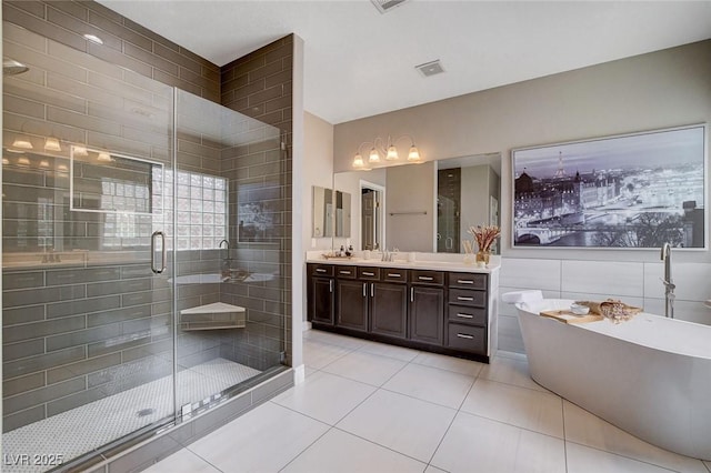 11342 Early Sun Ct, Las Vegas, NV 89135 - bathroom featuring a freestanding tub, tile patterned floors, vanity, and a stall shower