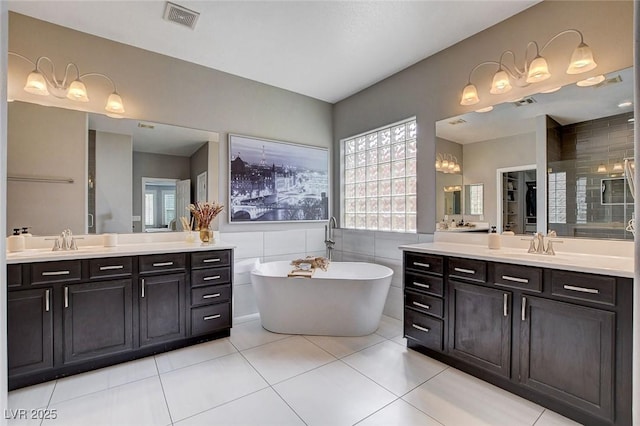11342 Early Sun Ct, Las Vegas, NV 89135 - full bath featuring tile patterned floors, a healthy amount of sunlight, two vanities, and visible vents