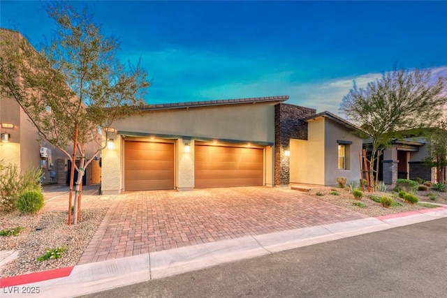 93 Reverie Heights Ave, Henderson, NV 89011 - view of front of property with a garage, stucco siding, stone siding, and decorative driveway