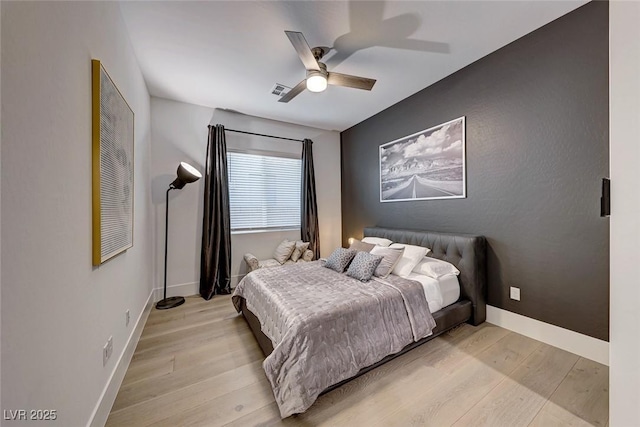 93 Reverie Heights Ave, Henderson, NV 89011 - bedroom with light wood-style flooring, a ceiling fan, and baseboards