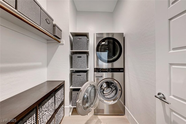 93 Reverie Heights Ave, Henderson, NV 89011 - laundry room featuring stacked washer / dryer, laundry area, wood finished floors, and baseboards