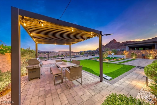 93 Reverie Heights Ave, Henderson, NV 89011 - patio terrace at dusk with a grill, a mountain view, a pergola, and fence