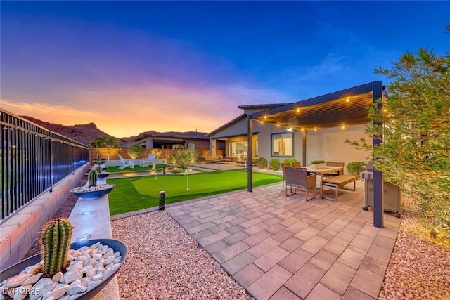 93 Reverie Heights Ave, Henderson, NV 89011 - patio terrace at dusk with a fenced backyard and outdoor dining space
