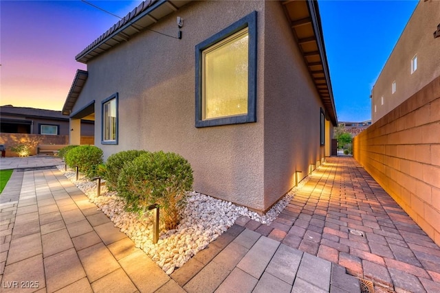 93 Reverie Heights Ave, Henderson, NV 89011 - view of side of property featuring a patio, stucco siding, a tiled roof, and fence