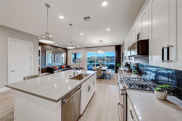 93 Reverie Heights Ave, Henderson, NV 89011 - kitchen with visible vents, a sink, recessed lighting, light wood finished floors, and stainless steel appliances