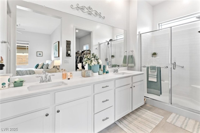 916 Belleforte Ln, Las Vegas, NV 89138 - ensuite bathroom featuring double vanity, a shower stall, plenty of natural light, and tile patterned flooring