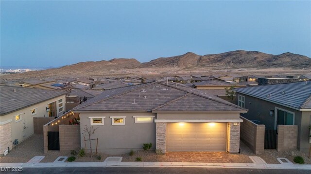 916 Belleforte Ln, Las Vegas, NV 89138 - view of front of property with an attached garage, a residential view, stucco siding, and a mountain view