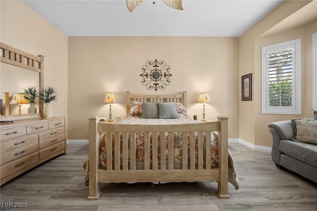 bedroom with wood finished floors and baseboards