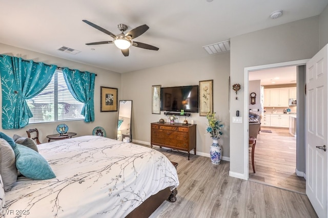 bedroom featuring ceiling fan, light wood finished floors, baseboards, and visible vents