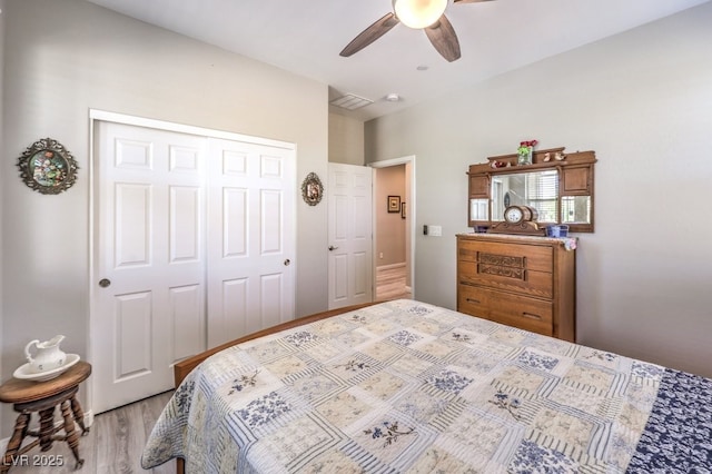 bedroom with a ceiling fan, a closet, visible vents, and light wood-type flooring