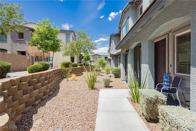 view of community featuring fence and a residential view