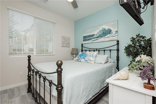bedroom featuring baseboards, ceiling fan, and visible vents