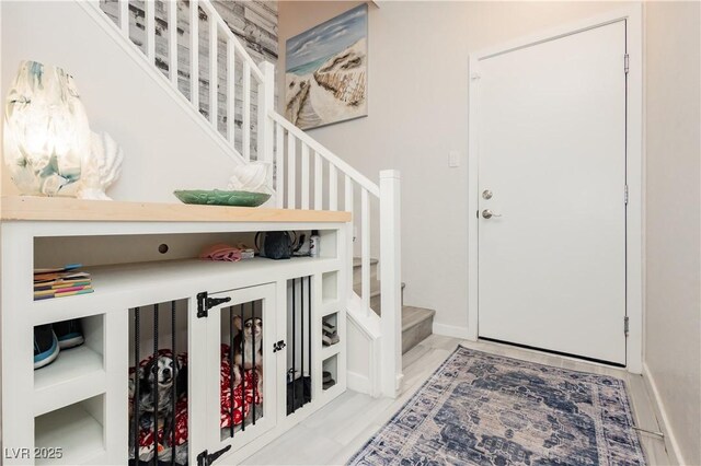 foyer entrance with baseboards and stairway