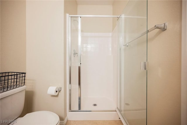 full bath featuring toilet and a stall shower