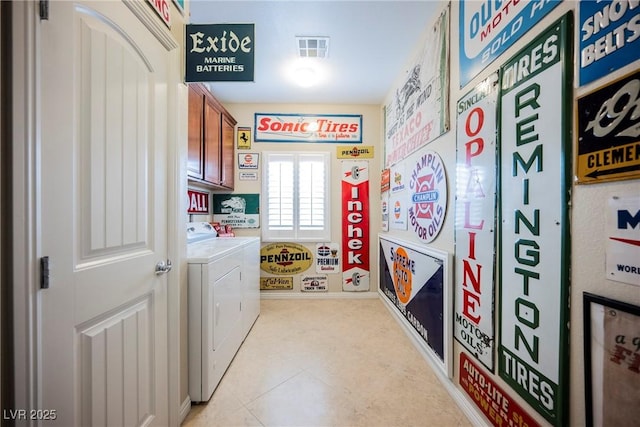 laundry room featuring cabinet space, visible vents, and washer and clothes dryer