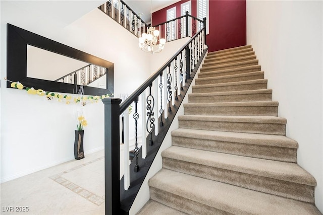 stairway featuring a high ceiling, tile patterned flooring, baseboards, and an inviting chandelier