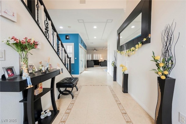 hallway featuring baseboards, stairs, and recessed lighting