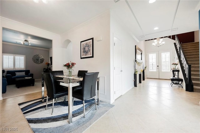 dining space featuring plenty of natural light, ornamental molding, a notable chandelier, and light tile patterned floors