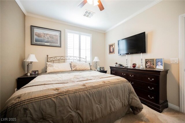 bedroom with baseboards, visible vents, light colored carpet, and ornamental molding