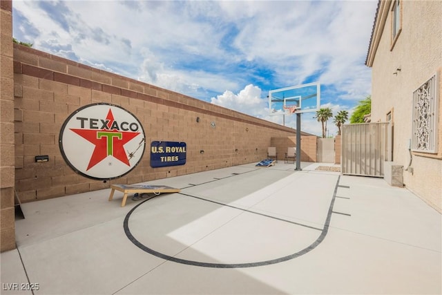 view of basketball court with community basketball court and fence