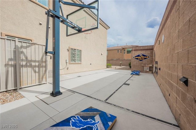 view of basketball court with fence