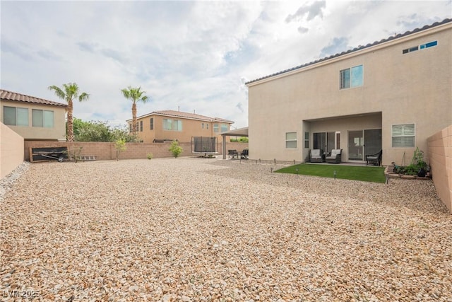 view of yard with a patio area, a fenced backyard, and a trampoline