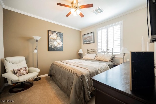 carpeted bedroom with ceiling fan, baseboards, crown molding, and visible vents