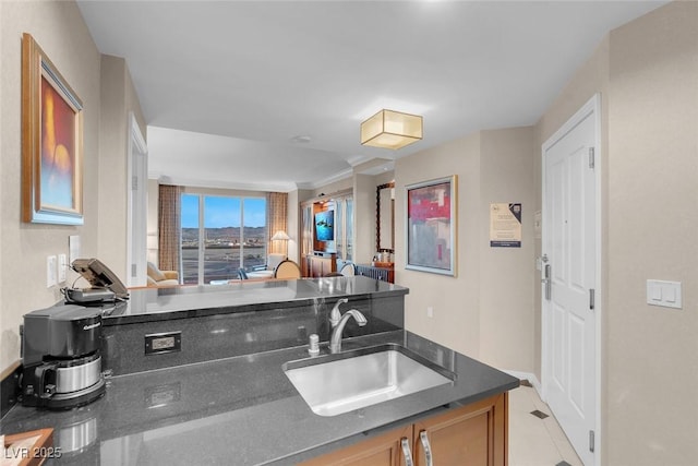 125 E Harmon Ave Unit 2220, Las Vegas, NV 89109 - kitchen with dark stone counters, light tile patterned floors, and a sink