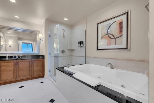 125 E Harmon Ave Unit 2220, Las Vegas, NV 89109 - full bath with recessed lighting, a shower stall, vanity, a whirlpool tub, and tile patterned flooring