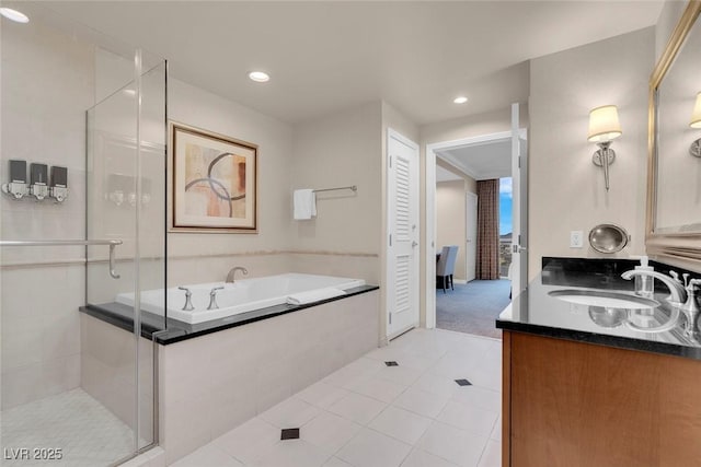 125 E Harmon Ave Unit 2220, Las Vegas, NV 89109 - full bathroom featuring recessed lighting, tile patterned floors, vanity, a stall shower, and a garden tub