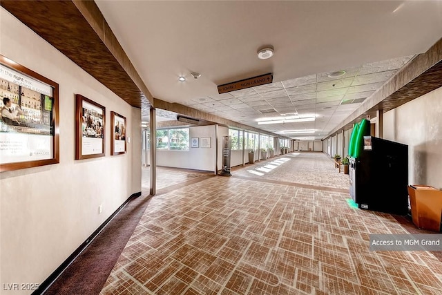 145 E Harmon Ave Unit 2411, Las Vegas, NV 89109 - hall featuring brick patterned flooring, baseboards, and a paneled ceiling
