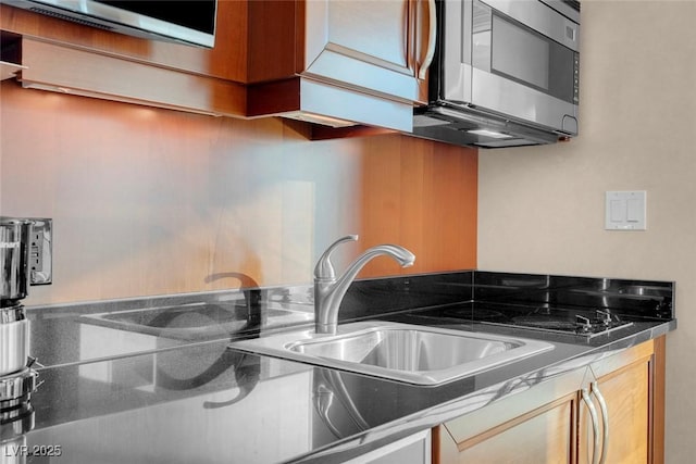 145 E Harmon Ave Unit 2411, Las Vegas, NV 89109 - kitchen featuring stainless steel microwave, dark countertops, and a sink