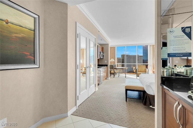 145 E Harmon Ave Unit 2411, Las Vegas, NV 89109 - bedroom featuring ornamental molding, baseboards, french doors, and light carpet