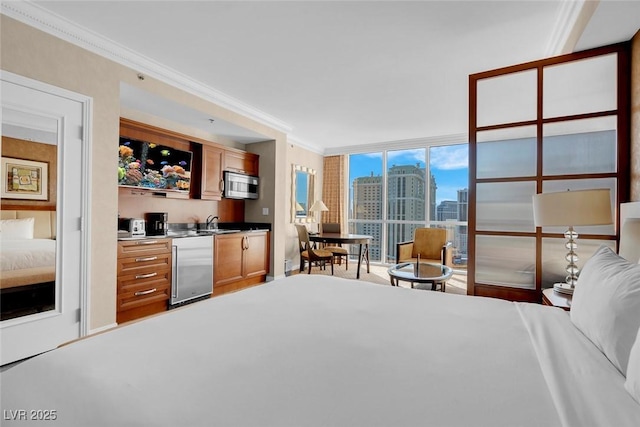 145 E Harmon Ave Unit 2411, Las Vegas, NV 89109 - bedroom featuring crown molding, a city view, floor to ceiling windows, and wet bar