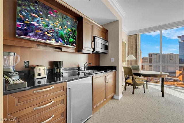 145 E Harmon Ave Unit 2411, Las Vegas, NV 89109 - kitchen featuring stainless steel appliances, a sink, dark countertops, floor to ceiling windows, and ornamental molding