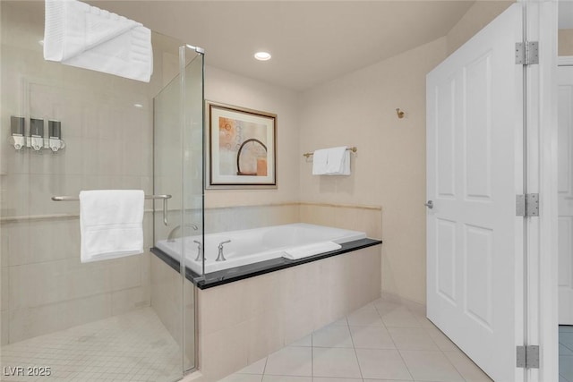 145 E Harmon Ave Unit 2411, Las Vegas, NV 89109 - bathroom with tile patterned flooring, a bath, and a stall shower