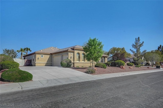 8370 Unicorn St, Las Vegas, NV 89131 - mediterranean / spanish home with a garage, stucco siding, and driveway