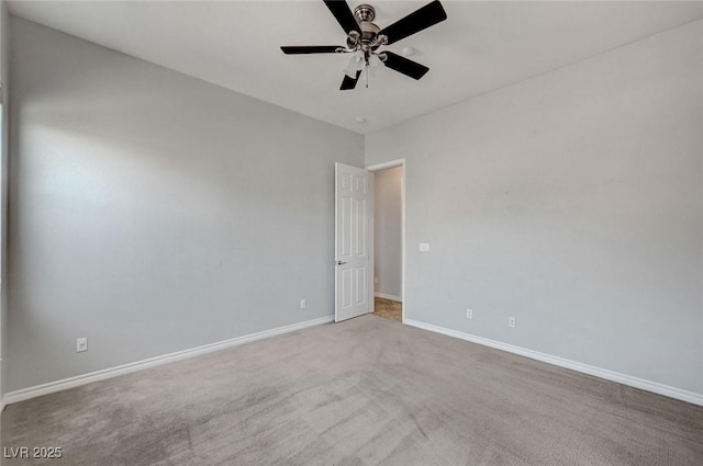 carpeted empty room with baseboards and a ceiling fan