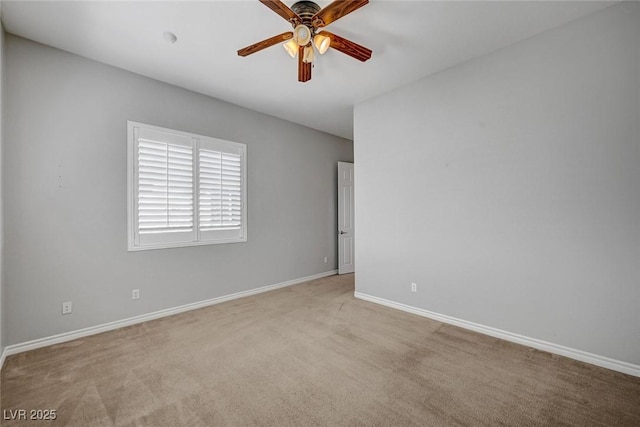 spare room featuring a ceiling fan, baseboards, and carpet