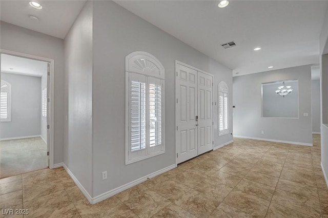 foyer entrance featuring baseboards, recessed lighting, a chandelier, and visible vents
