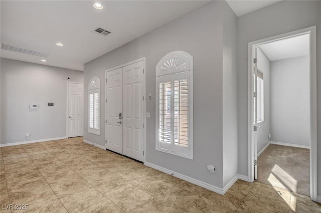 tiled foyer entrance featuring baseboards, recessed lighting, and visible vents