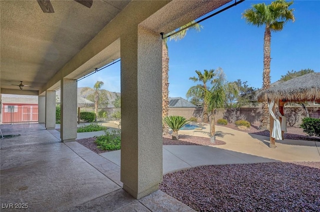 view of patio / terrace with a gazebo, a fenced backyard, and ceiling fan