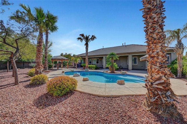 pool with fence, a patio, and a gazebo