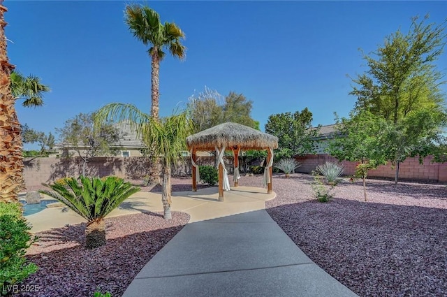 view of community featuring a patio, a gazebo, and a fenced backyard